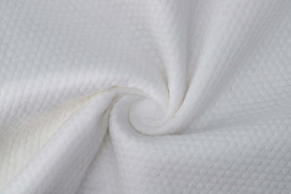 Close-up of soft, absorbent white fabric, ideal for towels, showcasing texture and quality.