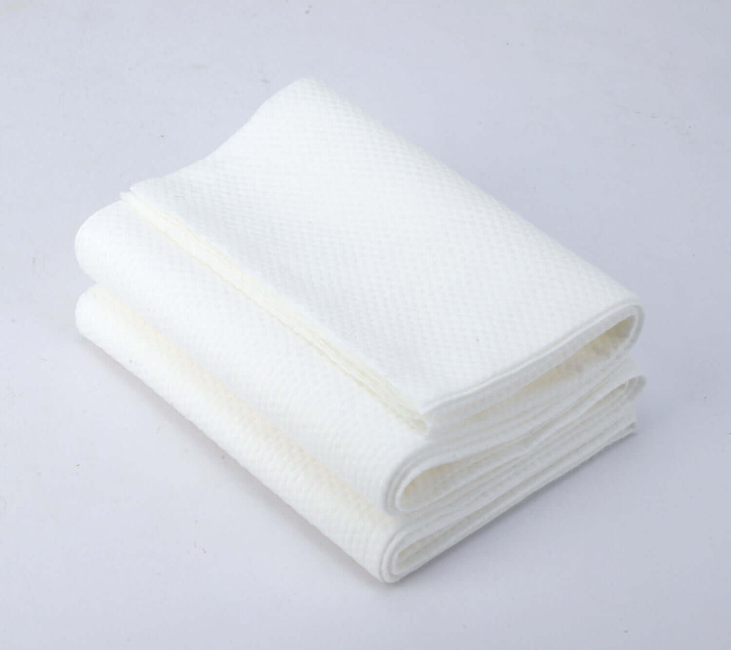 JITTY Premium Portable Disposable Bath Towels, soft, absorbent, hygienic, in a stack, ideal for homes, hotels, and gyms.